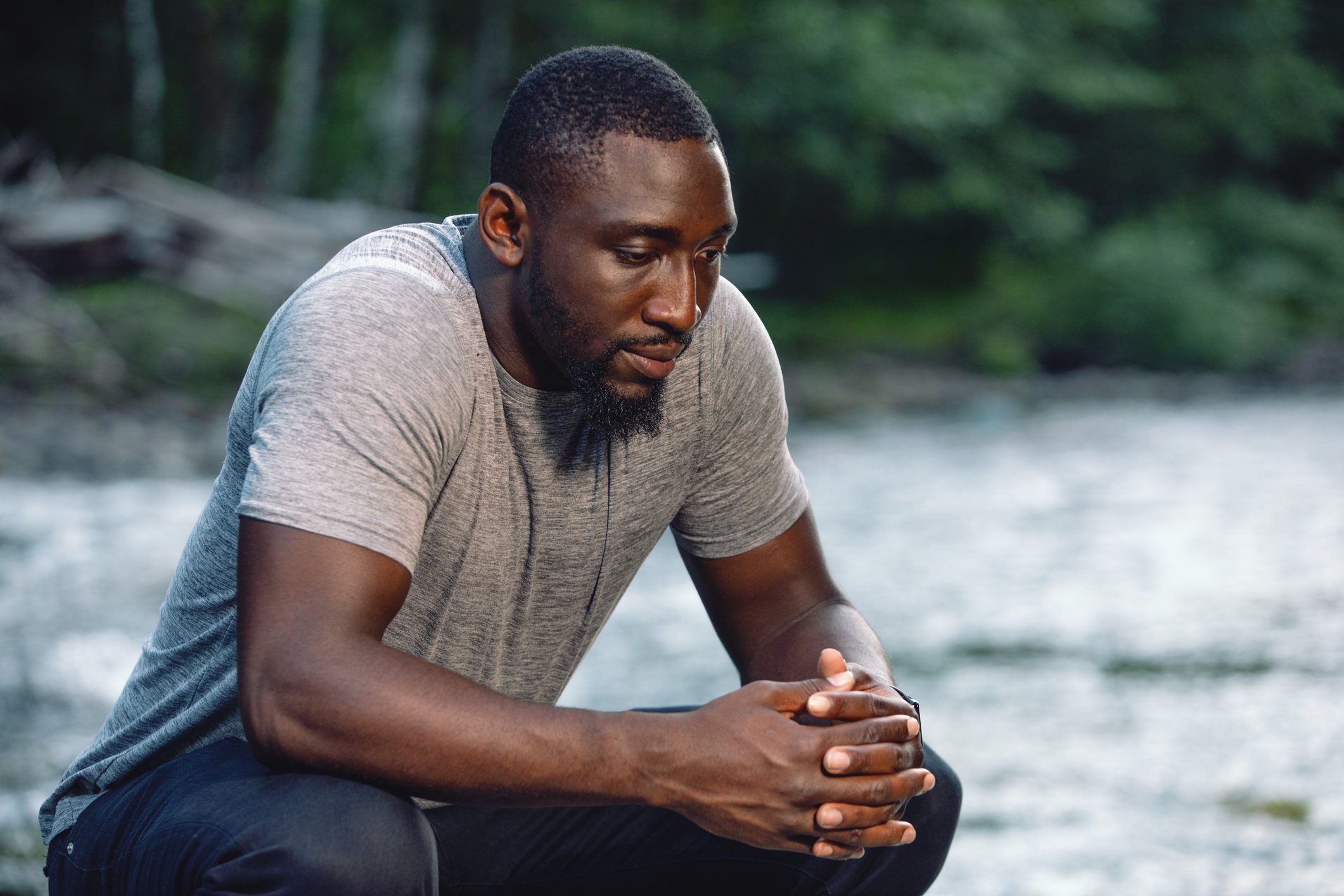 Man crossing his hands in thought.